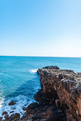 Fototapeta na wymiar Amazing blue ocean with rock, waves and blue clear sky
