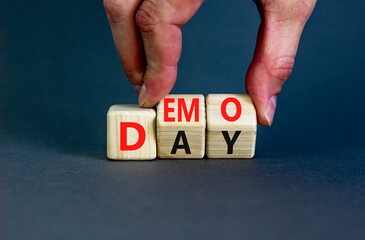 Demo day symbol. Concept words Demo day on wooden cubes. Businessman hand. Beautiful grey table grey background. Business and demo day concept. Copy space.