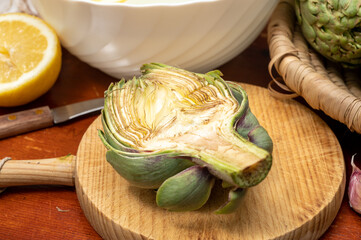 Cooking of green heads of artichokes plants, how to peel artichoke