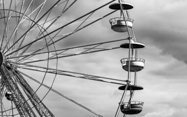 Carousel Ferris wheel with colorful cabins. Fun fair attractions. A carousel gondola isolated against a blue sky. Ferris wheel carousel design.