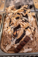 Assortment of colorful artisanal ice cream in refrigerator close up in Spain