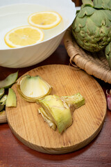 Cooking of green heads of artichokes plants, how to peel artichoke