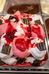 Assortment of colorful artisanal ice cream in refrigerator close up in Spain