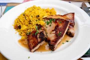 Andalusian cuisine, spicy cous-cous with grilled pork ham filet