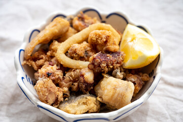 Spanish sea food, cripsy deep fried baby octopus, fish, calamari rings served with lemon