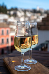 Tasting of Spanish sweet and dry fortified Vino de Jerez sherry wine with view on roofs and houses of old andalusian town