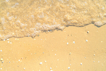 Sand with stones and sea water top view background