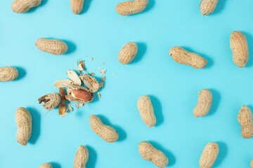 Peanuts pattern on blue background. Backdrop food nut texture. Minimal concept.