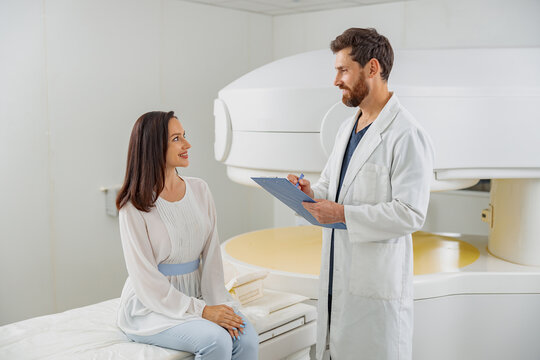 Woman patient talking with doctor radiologist before MRI or CT scan in clinic
