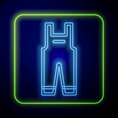 Glowing neon Work overalls icon isolated on blue background. Vector