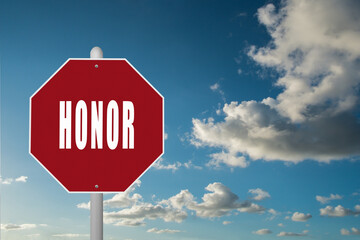 Red stop sign with the word Honor on a blue sky background.