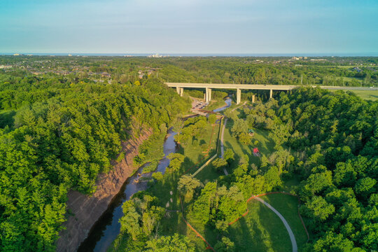 Aerial shot of a bridge going over a valley in the summer