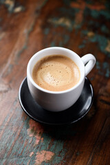 Cup of coffee on wooden background. Close up.	