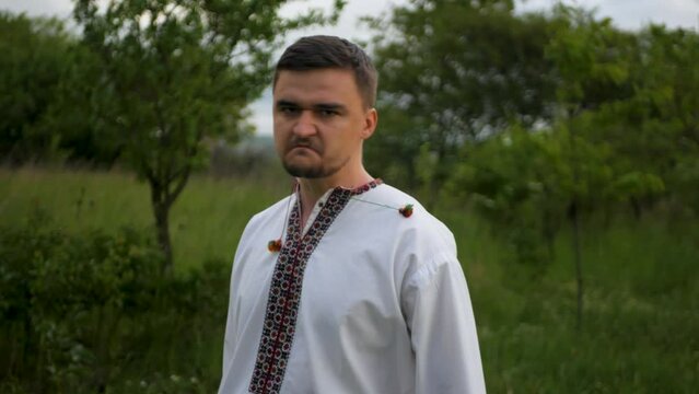 Angry resentful Ukrainian man in embroidered vyshyvanka shaking head and refusing to forgive enemy. Mad unforgiving male in national outfit rejecting apologies. Concept of declining pardon  
