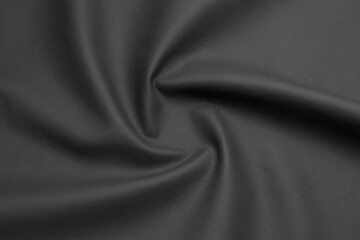 black artificial leather with waves and folds on PVC base