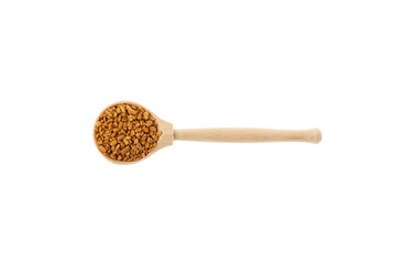 Fenugreek seeds in wooden spoon on white background. Healthy seeds of plant Trigonella foenum-graecum. Used in culinary and medicine