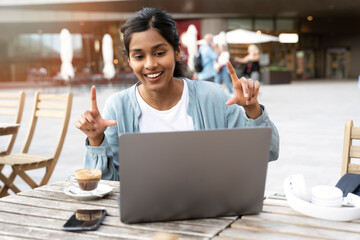 Young smiling Indian woman freelancer using laptop computer communication online, having video call sitting in cafe. Asian student studying, online lesson concept - obrazy, fototapety, plakaty