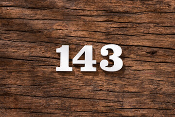 Number 143 in wood, isolated on rustic background