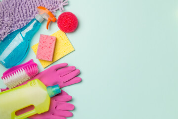 Many different house cleaning products on color background, top view