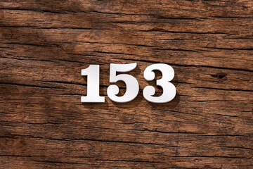Obraz premium Number 153 in wood, isolated on rustic background