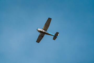 light-engine aircraft against a backdrop of blue skies at sunset