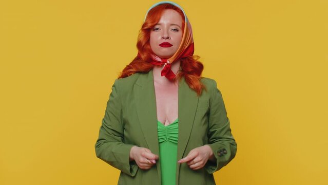 Greedy avaricious redhead young woman showing fig negative gesture, you dont get it anyway. Rapacious, avaricious, acquisitive. Body language. Refusal fig sign. Ginger girl indoor on yellow background