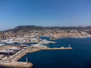 Obraz premium Panoramic aerial view on historical coastal Provencal city La Ciotat with large sailboat harbour and yacht shipyard, summer vacation in Provence, France
