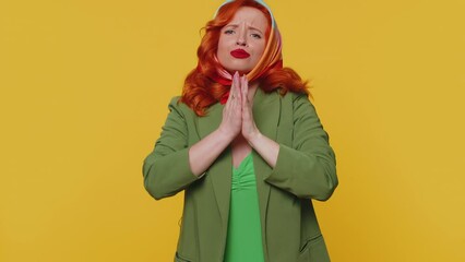 Need some more please give me. Woman showing a little bit gesture with sceptic smile, showing minimum sign, measuring small size asking for help. Ginger girl isolated alone on yellow studio background
