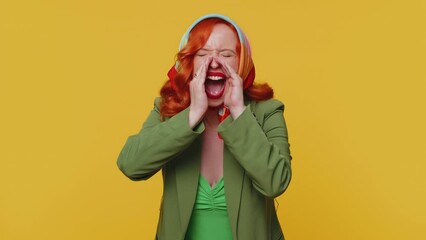 Expressive woman holding hands near mouth loudly screaming, shouting, yelling, announces discounts sale Hurry up, welcomes someone hello. Young redhead girl isolated alone on yellow studio background