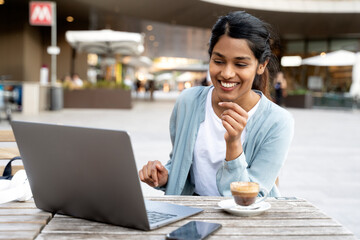 Young Confident Indian business woman using laptop computer working, planning startup, having video...