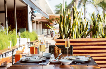 Fototapeta premium Photograph of food prepared on a table with glasses of champagne and trays around it and well prepared