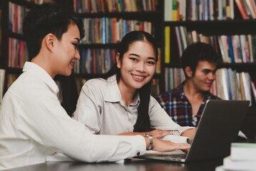 Female student doing a report with classmates