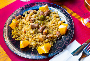 Traditional Spanish dish Migas tropezones from fried wheat flour with pieces of bacon, longaniza...