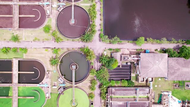 Aerial view High angle view Top down drone shot of the sewage treatment plant.The Solid contact clarifier tank type sludge recirculation in water treatment plant. Industrial wastewater treatment plant