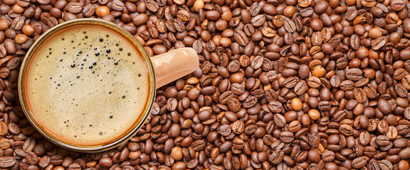 Cup of hot coffee on roasted beans. Banner for design