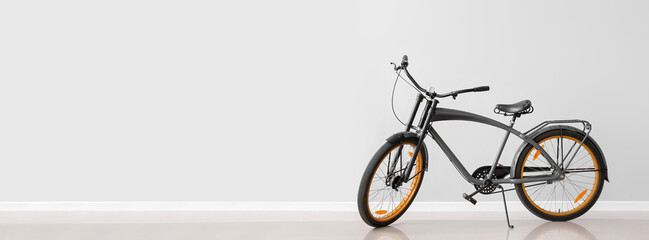 Modern bicycle on light background with space for text