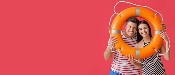 Beach rescuers holding lifebuoy on red background with space for text