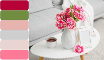 Vase with beautiful tulips, blank photo frame and cup of tea on table in room. Different color patterns