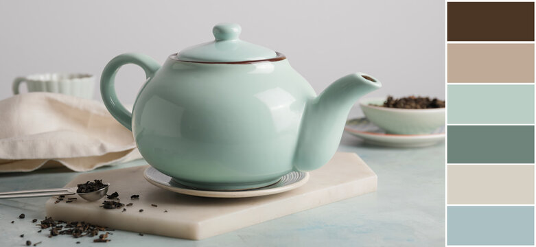 Teapot of hot beverage on table. Different color patterns