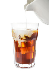 Milk pouring into glass with cold brew coffee on white background, closeup