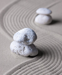 Fototapeta na wymiar Zen garden japanese garden zen stone with zen pattern in sand as background