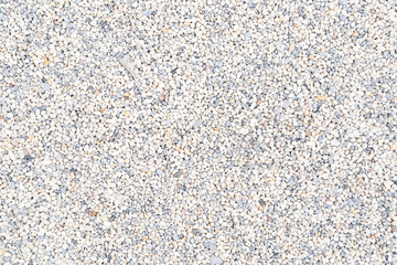 White pebble stone texture on the ground. The pebbles closely stone texture features