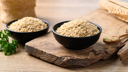 Organic Thai brown rice grain in bowl, Healthy food ingredients