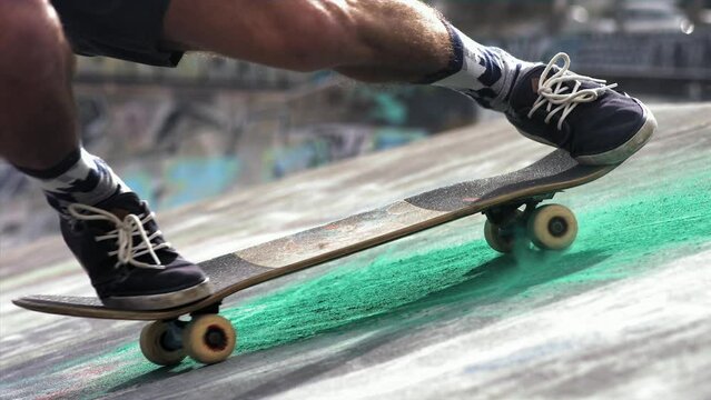 Super slow motion of skater sliding on a skateboard with dust in a concrete skatepark. Filmed on a high-speed cinema camera, 1000 fps