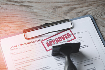 Loan approved on loan application form paper with rubber stamp on table, Loan approval business...
