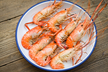 seafood plate fresh shrimp cooking on white plate background , shrimps prawns served on a food table - baked shrimp top view