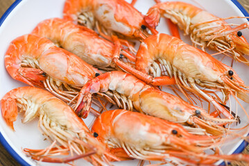 seafood plate fresh shrimp cooking on white plate background , shrimps prawns served on a food table - baked shrimp top view