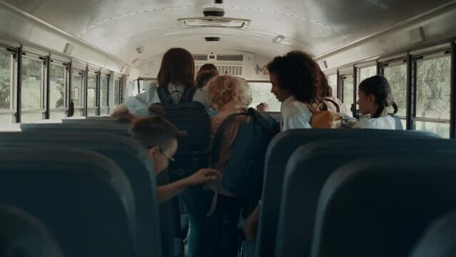Energetic pupils leave academic shuttle. Friendly crowd go out schoolbus.