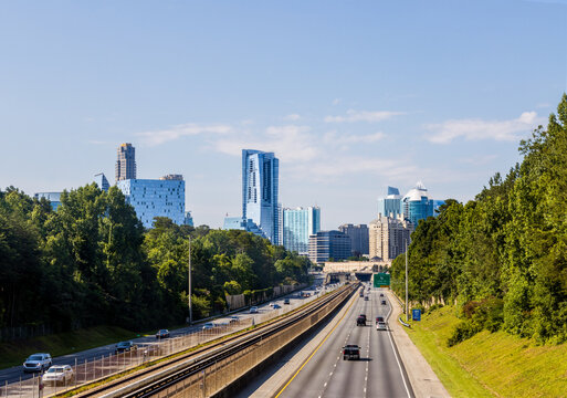 North Atlanta neighborhood of Buckhead displaying several buildings, city streets, hotels and high rises under a blue sky.