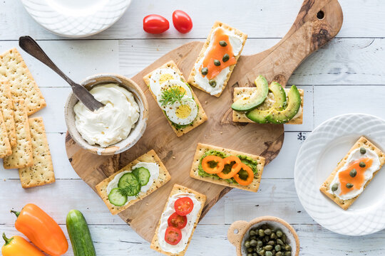 Top down view of everything crackers with various fresh savoury toppings.